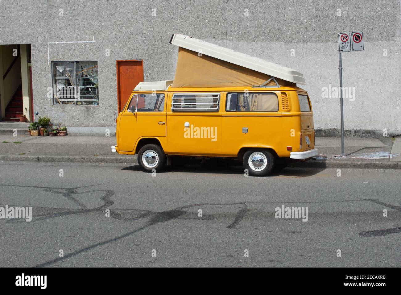 Here`s a vintage VW bus sitting on the street. This is probably from the early 1970`s. These were closely associated with hippies. Stock Photo
